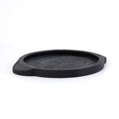 an empty black plate on a white background