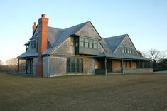 a large house sitting on top of a lush green field