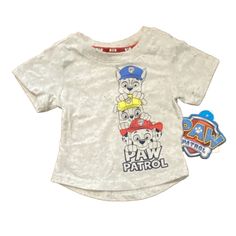 Get Ready For Some Adventure With This 18m Paw Patrol Shirt! Featuring Marshall And Chase From The Beloved Paw Patrol Series In A Solid Gray Color, This T-Shirt Is Perfect For Your Little One's Casual Everyday Wear. The Short Sleeves And Round Neckline With Pullover Closure Make It Easy To Dress Up Or Down. Made From A Comfortable Blend Of Polyester And Cotton, This Shirt Is Perfect For Walking, School, Or Any Other Everyday Activity. It Is Brand New With Tags And Comes In A Regular Fit Suitable Playtime Graphic Tee With Character Print, Graphic Tee With Character Print For Playtime, Graphic Tee Tops With Character Print For Playtime, Casual Tops With Character Print For Playtime, Pre-shrunk Cotton Tops For Playtime, Cotton Tops With Character Print For Playwear, Short Sleeve Shirt For Playtime, Graphic Tee Shirt For Playtime With Short Sleeves, Short Sleeve Graphic Tee For Playtime