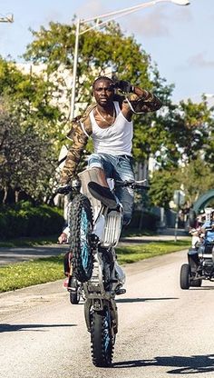 a man riding on the back of a dirt bike