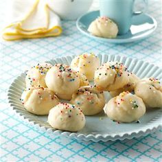 a plate full of cookies with sprinkles on them sitting on a table