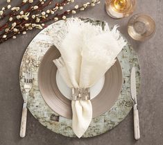 a place setting with white flowers and silverware