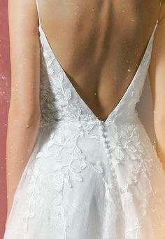 the back of a woman's white wedding dress