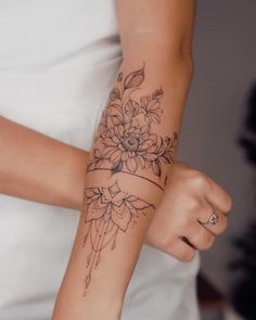 a woman with a flower tattoo on her arm