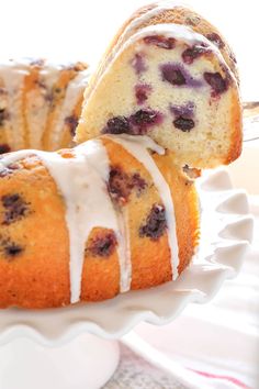 blueberry bundt cake with icing on a white plate