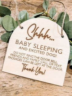 a baby sleeping and excited dog sign hanging on a door hanger that says, ohh thank you