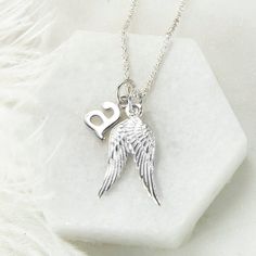 Our gorgeous Sterling Silver Guardian Angel Necklace make the perfect gift for friends and family of all ages. The design features two beautifully detailed angel wings which you can personalise with addition of an initial letter. We all need an Angel watching over us sometimes and this lovely sterling silver necklace is a great way of making someone feel loved and protected. Each necklace comes with a sterling silver belcher chain, available in five different lengths. To make this necklace personal, select an initial letter from the drop down menu. Truly a gift which is guaranteed to please This necklace is presented in a gift box complete with a blank gift card. Silver Sterling Silver Heart Pendant Initial Necklace, Silver Heart Pendant Initial Necklace In Sterling Silver, Personalized White Gold Charm Necklace As Gift For Her, Personalized Silver Charm Necklace As Gift For Her, Silver Initial Pendant Jewelry For Best Friend, Personalized White Gold Sterling Silver Charm Necklaces, Personalized Wing-inspired Jewelry Gift, Silver Heart Pendant Charm Necklace For Best Friend, Silver Wing-shaped Necklace For Valentine's Day