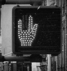 a black and white photo of a street sign with the word stop written on it