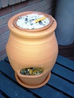 a large clay pot sitting on top of a wooden table