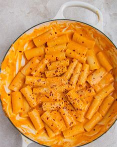 a pan filled with pasta and sauce on top of a table