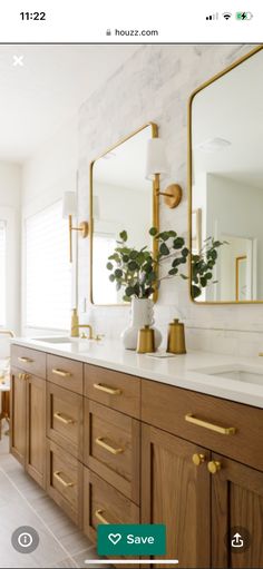 a bathroom with two sinks, mirrors and gold accents on the wall above them is an instagram