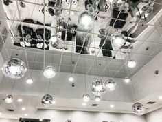 the ceiling is filled with shiny disco balls