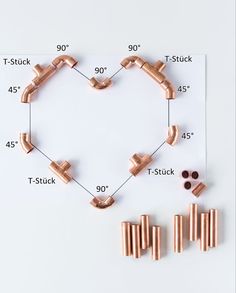 the copper parts are arranged on top of a sheet of paper with measurements for each part