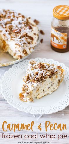 a white plate topped with a piece of cake next to a jar of caramel and pecan