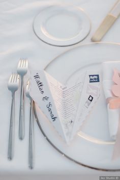 a white plate with silverware and napkins on it