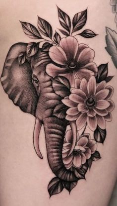 an elephant with flowers on it's back thigh is shown in black and white