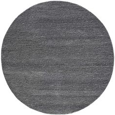 a round rug with dark gray carpeting