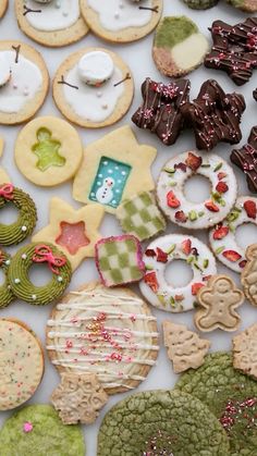 many decorated cookies and pastries on a table