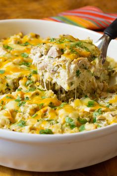 a white bowl filled with chicken and cheese casserole