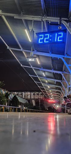 the clock is lit up in an airport terminal