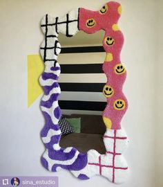 a mirror that has been made to look like it is decorated with different colors and shapes