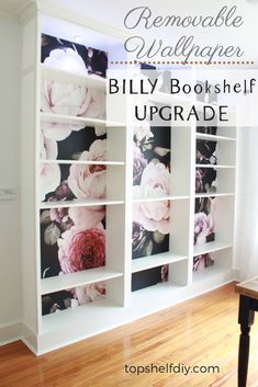 a white bookcase with flowers painted on the front and back sides, along with wooden flooring