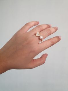 DESCRIPTION: This stunning 14K Gold Adjustable Freshwater Pearl Open Ring features a minimalist heart design, perfect for stacking or wearing alone. An elegant accessory that adds a touch of sophistication to any outfit. BEST FEATURES: The open ring can be easily adjusted for a perfect fit, ensuring comfort and versatility for all finger sizes. Crafted from 14K gold and genuine freshwater pearls, providing a luxurious look that stands the test of time. The delicate heart design adds a sweet, rom Luxury Elegant Everyday Pearl Ring, Luxury Adjustable Elegant Pearl Ring, Customer Gifts, Ring Minimalist, Elegant Accessories, Open Ring, Stacking Ring, Stackable Rings, Stacking Rings