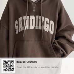 a man wearing a brown sweatshirt with the word san diego printed on it, standing in front of a white background