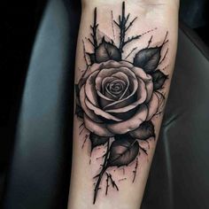 a black and white rose tattoo on the arm