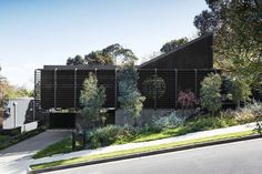 the house is surrounded by trees and bushes