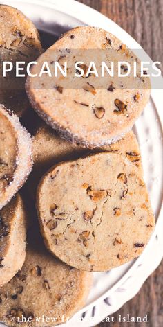 a white plate topped with cookies covered in powdered sugar