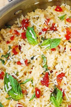 a pan filled with rice and vegetables on top of a table