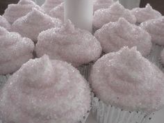 some cupcakes with white frosting and a candle