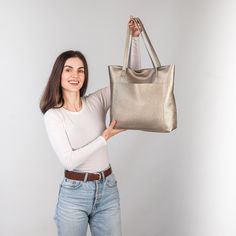 This handmade women tote bag is produced by Italian soft pebbled leather. It has one pocket inside. The bag has a high-quality zipper that secures your belongings. It holds the shape perfectly and you may be confident that your things like cell phone, tablet, lap-top are safe. This bag is simple, reliable, and durable. Its universal look allows using the tote bag for various purposes. One may take the bag to the work, shopping, meeting, or walk and feel comfortable with it in any condition. Size and Dimensions:       〰️ SMALL 〰️ Height: 12 inches (30 cm) Width (the top): 12.6 inches (32 cm) Width (the bottom): 9 inches (23 cm) Depth: 4.3 inches (11 cm)      〰️ MEDIUM 〰️ Height: 13.4 inches (34 cm) Width (the top): 14.6 inches (37 cm) Width (the bottom): 11 inches (28 cm) Depth: 4.3 inches Modern Satchel Bag With Pebbled Texture, Elegant Bags With Pebbled Texture For Everyday Use, Elegant Tote Bag With Pebbled Texture, Elegant Pebbled Texture Tote Bag, Pebbled Leather Tote Bag, Travel Shoulder Bag With Pebbled Texture Tote, Travel Tote Shoulder Bag With Pebbled Texture, Rectangular Shoulder Bag With Pebbled Texture, Modern Bags With Pebbled Texture For Daily Use