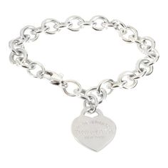 Tiffany & Co. Return To Tiffany Heart Tag Bracelet in Sterling Silver  PRIMARY DETAILS  SKU: 139591  Listing Title: Tiffany & Co. Return To Tiffany Heart Tag Bracelet in Sterling Silver  Condition Description: Tiffany reinvents a classic with the Return To Tiffany collection. Originally designed in 1969, the Tiffany keyring is the source of inspiration behind this line-up, which is defined by its engraved heart-shaped pendant.     Retails for 525 USD. In excellent condition and recently polished. 8 inches in length. Comes with Box;  Brand: Tiffany & Co.  Collection/Series: Return To Tiffany  Metal Type: Sterling Silver  Metal Purity: 925  Chain or Bracelet Length (in): 8  Pre-Owned Jewelry Condition: Excellent  SIDE STONE INFORMATION  Original Box?: Yes  Original Papers?: No  This item has Tiffany And Co Necklace Heart, Chanel Charm Bracelet, Tiffany Bracelet, Tiffany And Co Bracelet, Contemporary Bracelets, Tiffany And Co Necklace, Tiffany Bracelets, Return To Tiffany, Vintage Charm Bracelet