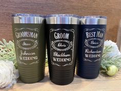 three different colored tumblers sitting next to each other on top of a wooden table