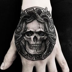 a hand with a skull and snake on it