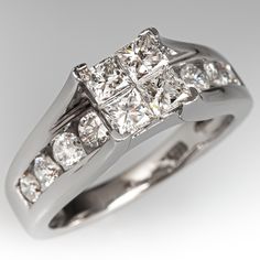 a white gold ring with three princess cut diamonds