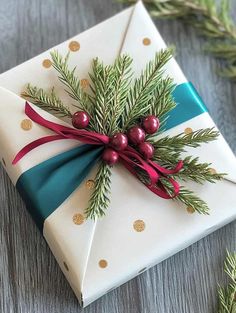 a present wrapped in white paper with green and red ribbon