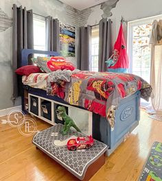 a child's bedroom with cars themed bedding and toys