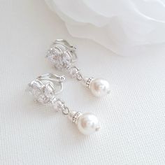 Dainty Clip On Earrings with Pearl Drop for Brides & Bridesmaids This is a pretty pair of clip-on earrings for brides and bridesmaids with no ear piercings. Dainty and comfortable to wear, the earrings are made of marquise and teardrop cubic zirconia ear tops with dangling pearls. The pearls are available in white which is a soft white and goes well with white or light ivory dresses and cream pearls which go well with darker ivory dresses. The clip-on earrings can be purchased in three finishes White Pearl Drop Clip-on Earrings For Wedding, Pearl White Clip-on Earrings For Wedding, Adjustable White Pearl Earrings For Wedding, White Clip-on Pearl Earrings For Wedding, Pearl White Clip-on Earrings With Pearl Drop For Wedding, Adjustable Clip-on Earrings For Wedding, Adjustable Pearl Earrings For Wedding, White Round Clip-on Earrings For Wedding, White Clip-on Bridal Earrings For Wedding