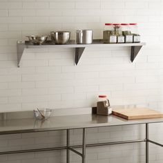 a kitchen counter with two shelves above it