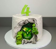 a birthday cake with the hulk face on it's side and number four in the middle