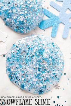 two blue and white snowflake slime balls sitting next to each other