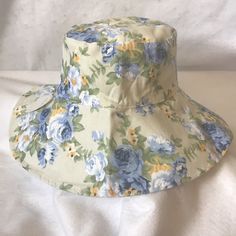 Wide Floppy Brim Foldable Floral Bucket Hat. Hat Is 100% Cotton And Feels Similar To A Canvas Texture. Blues, Yellows And Greens On A Light Khaki Colored Background. Perfect For Spring And Summer Wear For Outdoor Activities To Protect From The Sun. Great For Beach Gardening Sun Shade Cruising Walking Gift Mom Grandma Non-Crushable, Packable Bad Hair Day Cover Up Bucket Hat Sunshade Outdoor Head Wear Vacation Poolside Rainy Weather New With Tags Bucket Hat Painting, Hat Painting, Walking Gifts, Raffia Sun Hat, Brown Fedora, Floral Bucket Hat, Womens Visor, Painted Hats, Stocking Cap