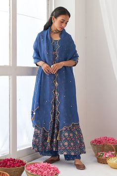 Blue floral print anrakali with hand embroidered detail. Paired with embroidered hem pant and dupatta with tassels.
Component: 3
Pattern: Hand embroidered, Printed
Type Of Work: Mirror work, Digital print
Neckline: Square
Sleeve Type: Three quarter
Fabric: Cotton silk, Organza
Color: Blue
Other Details: 
Scallop dupatta
Hand embroidered mirror tassels
Note: Basket held by the model is not for sale
Occasion: Mehendi, Reception - Aza Fashions Unstitched Cotton Silk Choli With Dupatta, Unstitched Chanderi Anarkali Choli, Blue Slub Silk Kurta With Sheer Dupatta, Designer Tussar Silk Sharara With Sheer Dupatta, Tussar Silk Anarkali Floor-length Set, Designer Tussar Silk Sharara For Navratri, Anarkali Tussar Silk Set With Traditional Drape, Anarkali Tussar Silk Set, Eid Unstitched Cotton Silk Choli