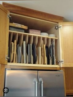 a kitchen cabinet filled with dishes and utensils