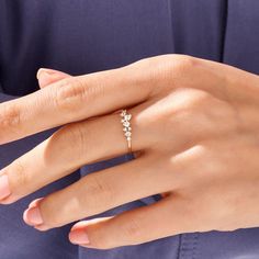 a woman's hand with a diamond ring on it