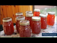 there are many jars that have red liquid in them on the table next to each other