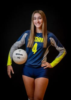 a female volleyball player is posing for a photo